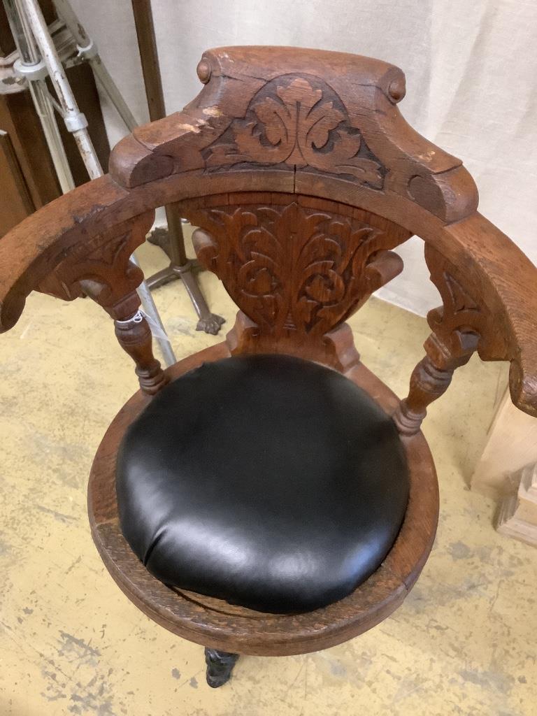 A continental carved oak and cast iron music chair